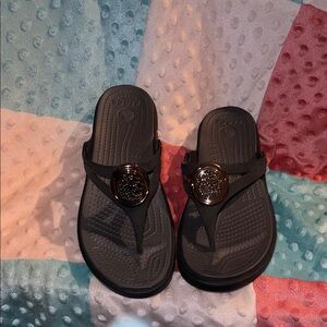 Crocs Black Wedge Flip Sandals with Gold Medallion